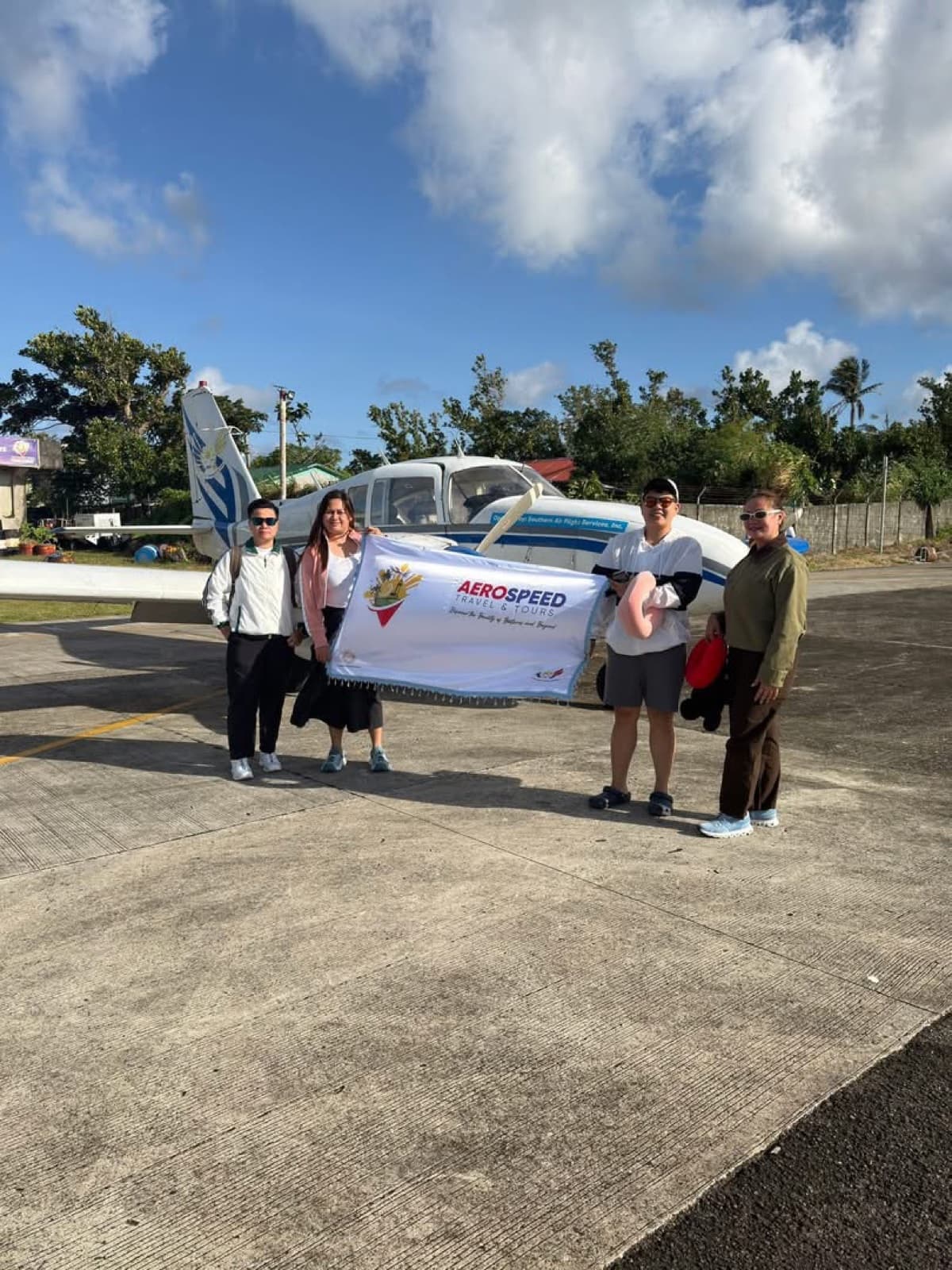 AeroSpeed travelers standing with a light aircraft in Batanes