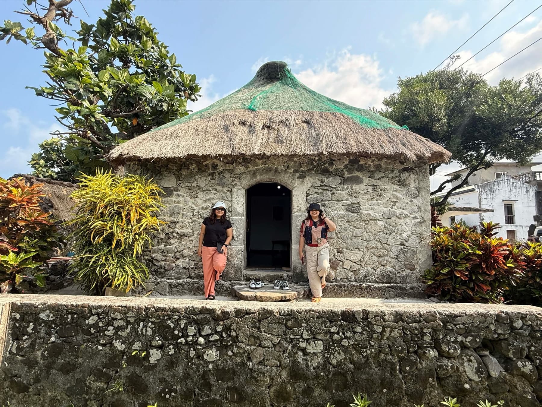 Travelers visiting a traditional Ivatan stone house