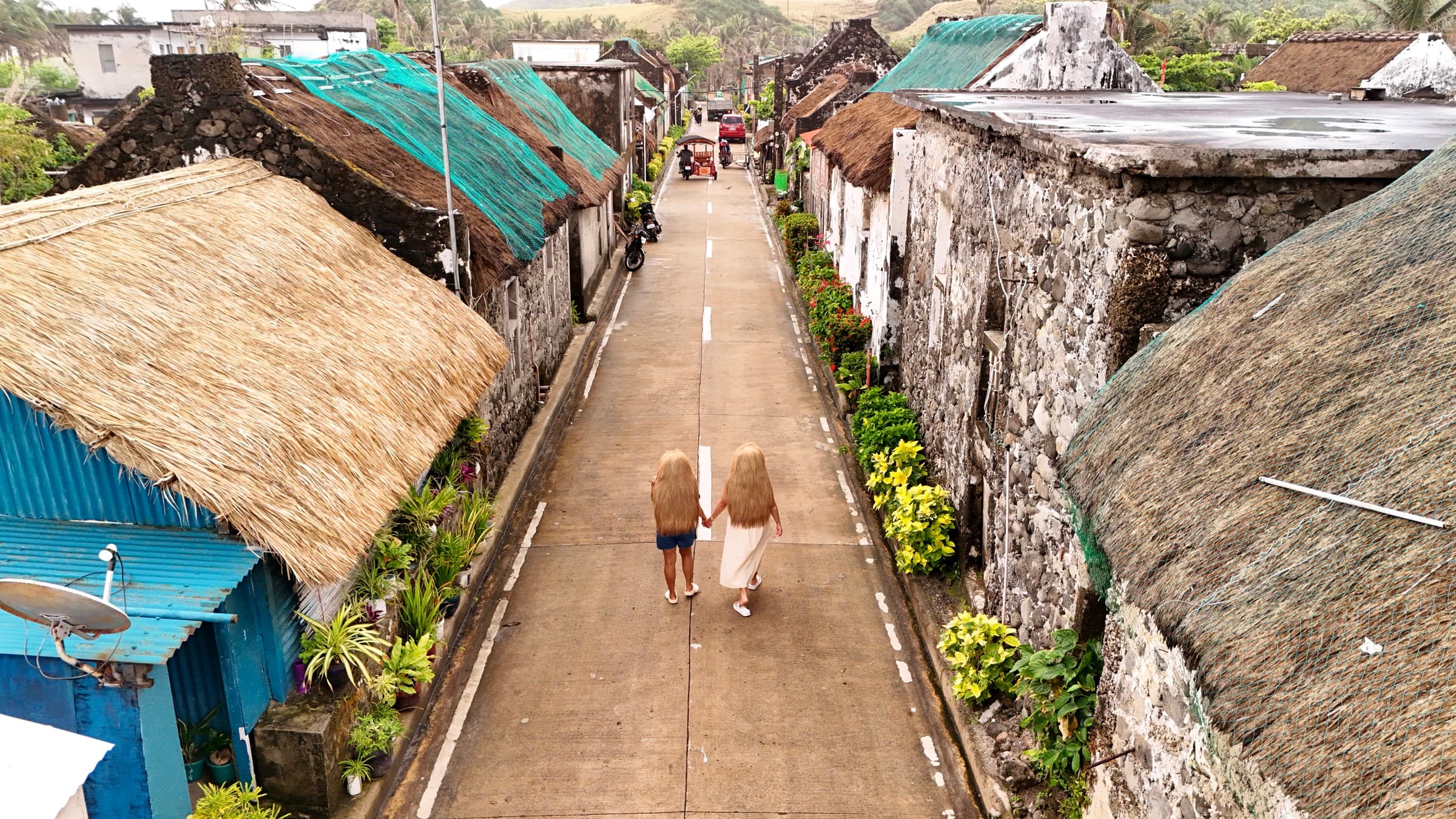 Traditional stone village set against green mountains in Sabtang