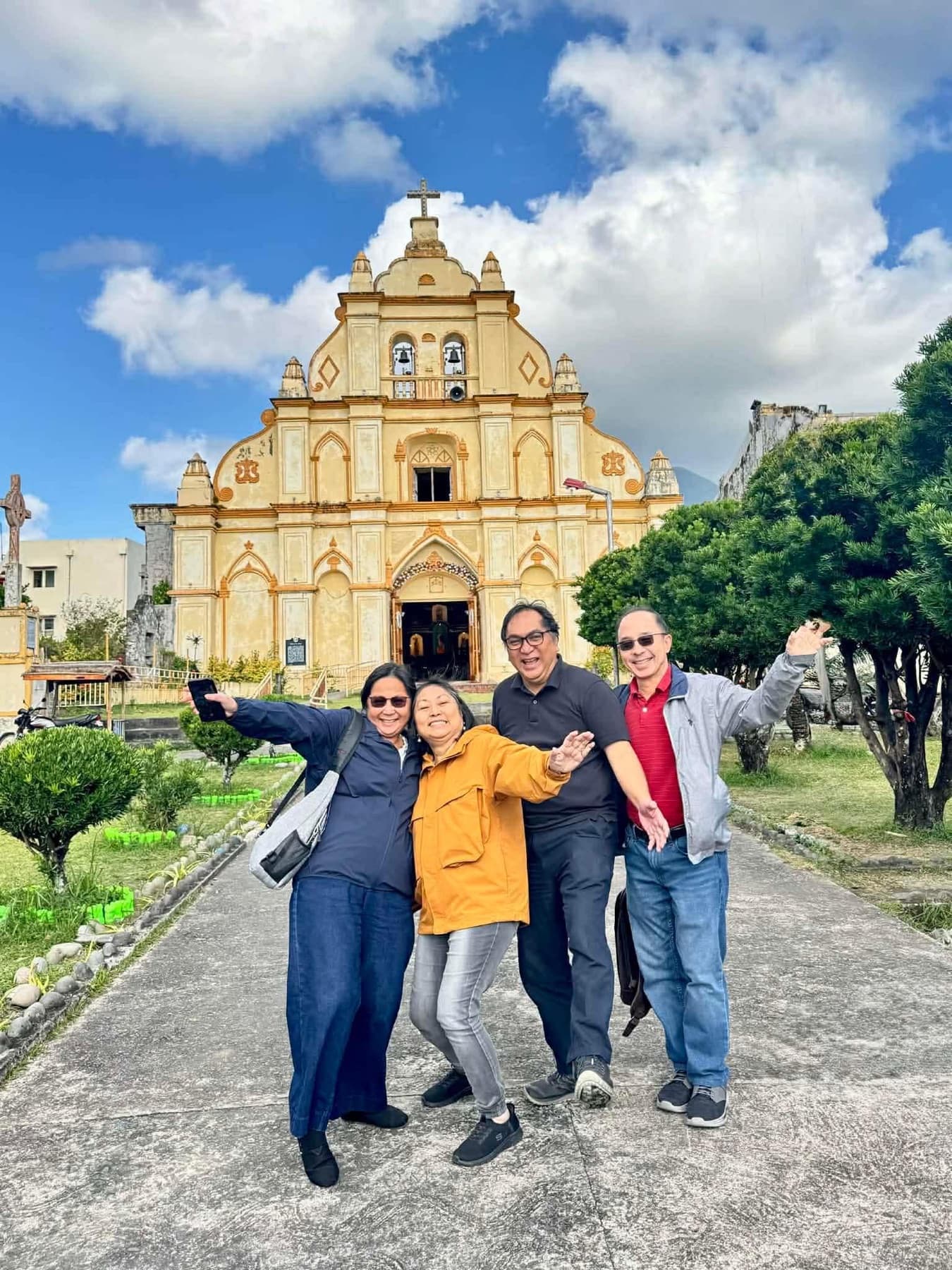 Travelers outside a church in Basco, Batanes