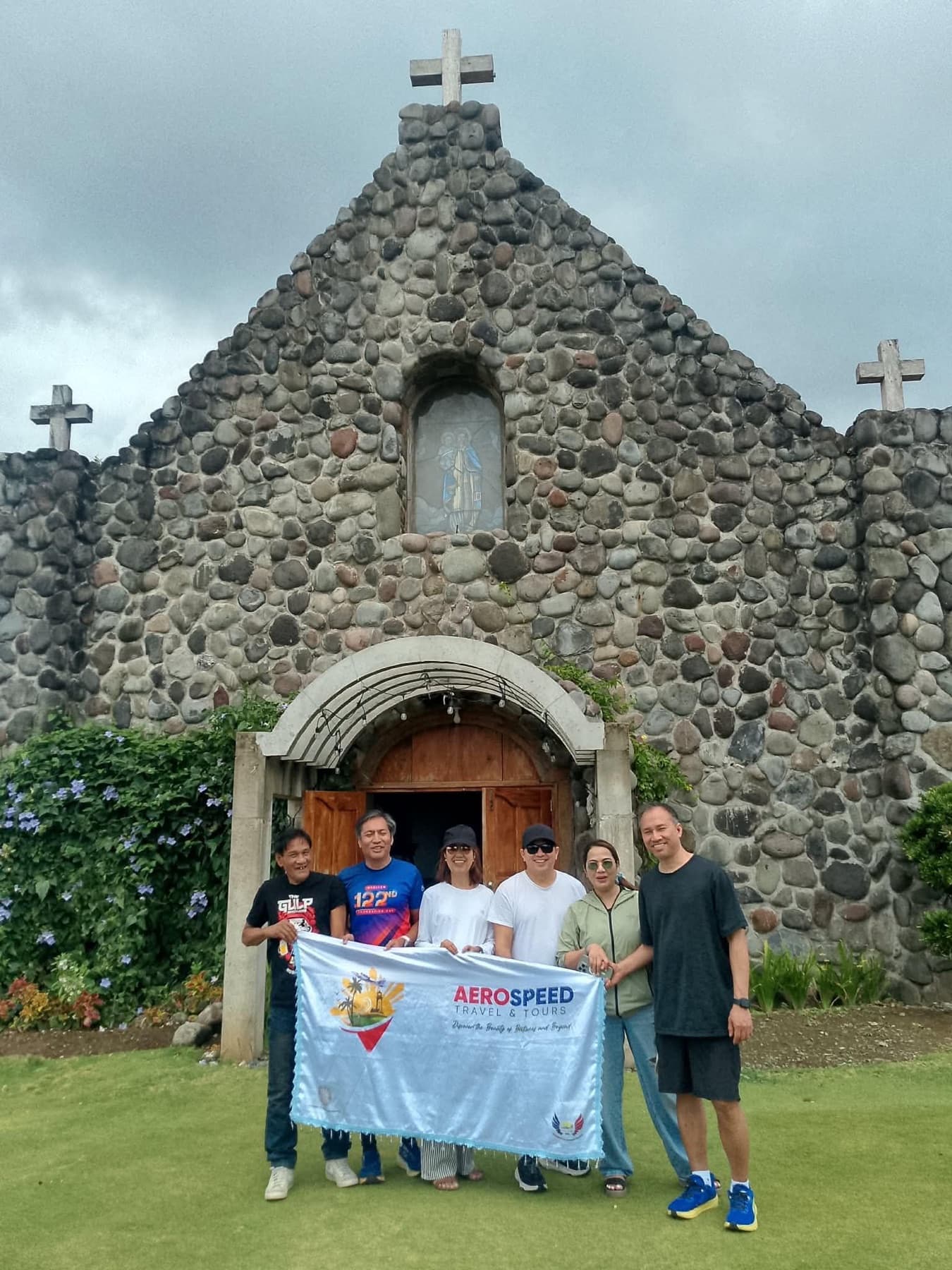 Guests with an AeroSpeed banner in the Batanes landscape
